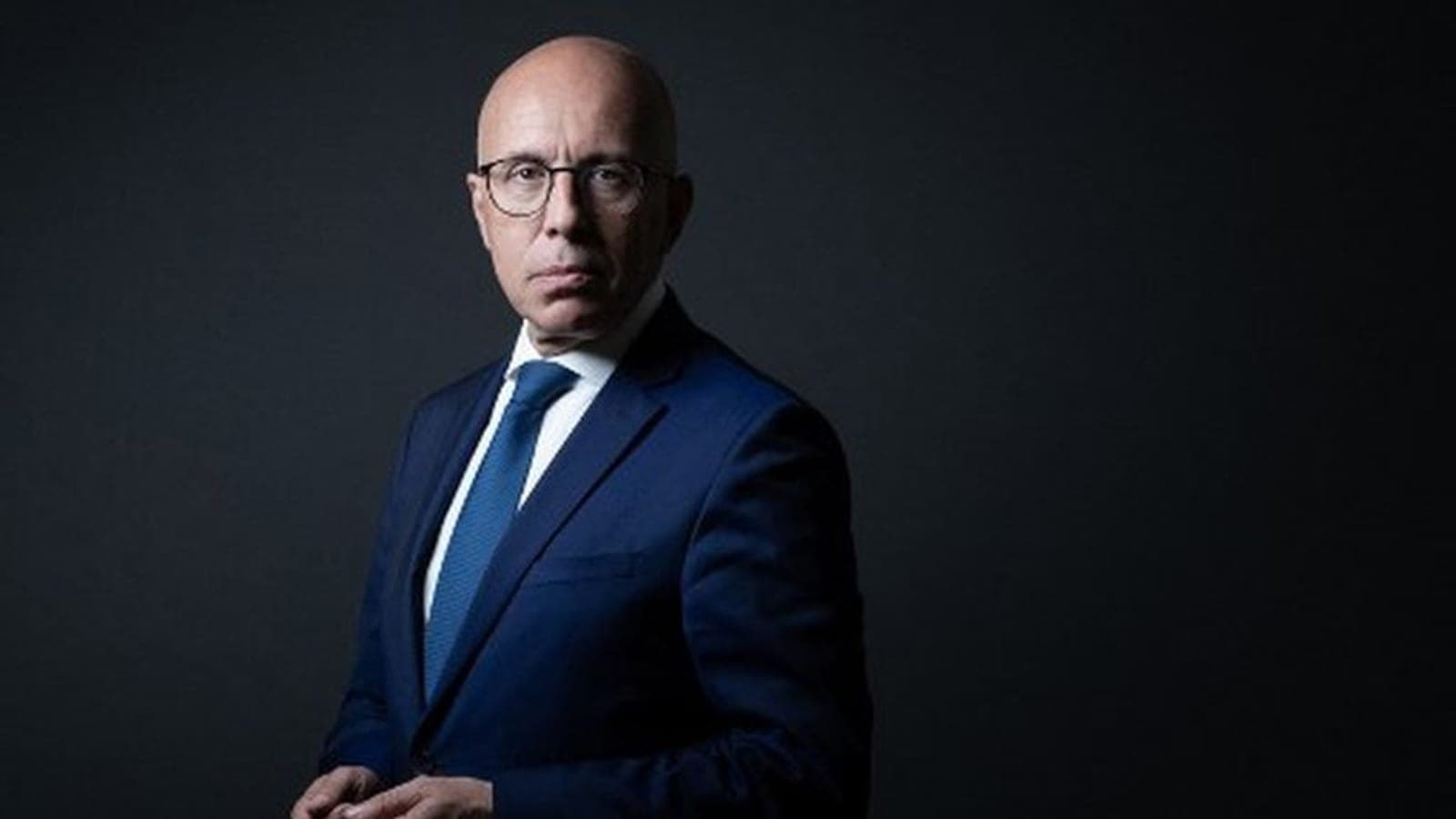 Eric Ciotti photographed in a studio portrait against a dark background.