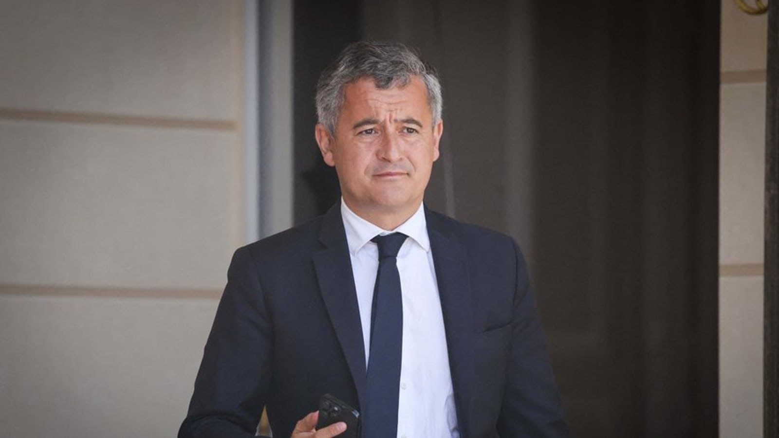 Gerald Darmanin photographed leaving a government building.