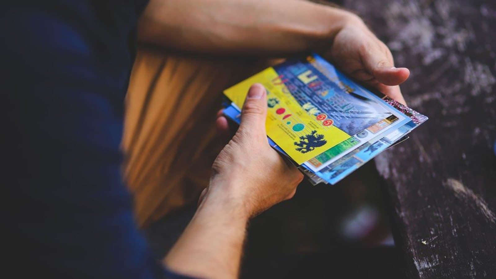 A person holding a small fan of scratch cards. Illustrative photograph, not the winner in this story.