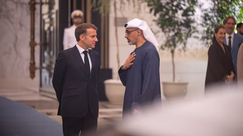 Emmanuel Macron and UAE officials at a signing ceremony in Abu Dhabi